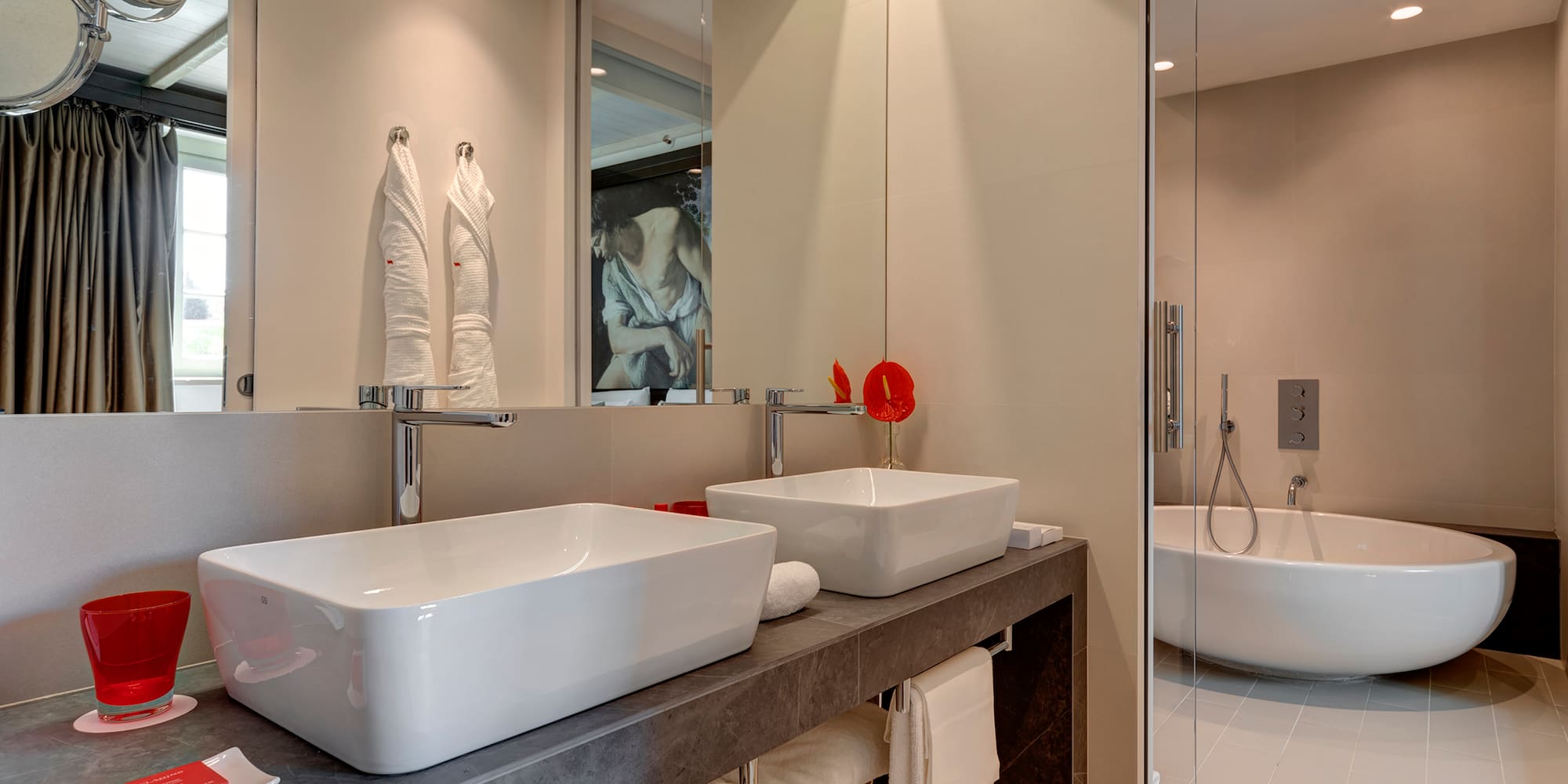 a bathroom with two sinks and a shower