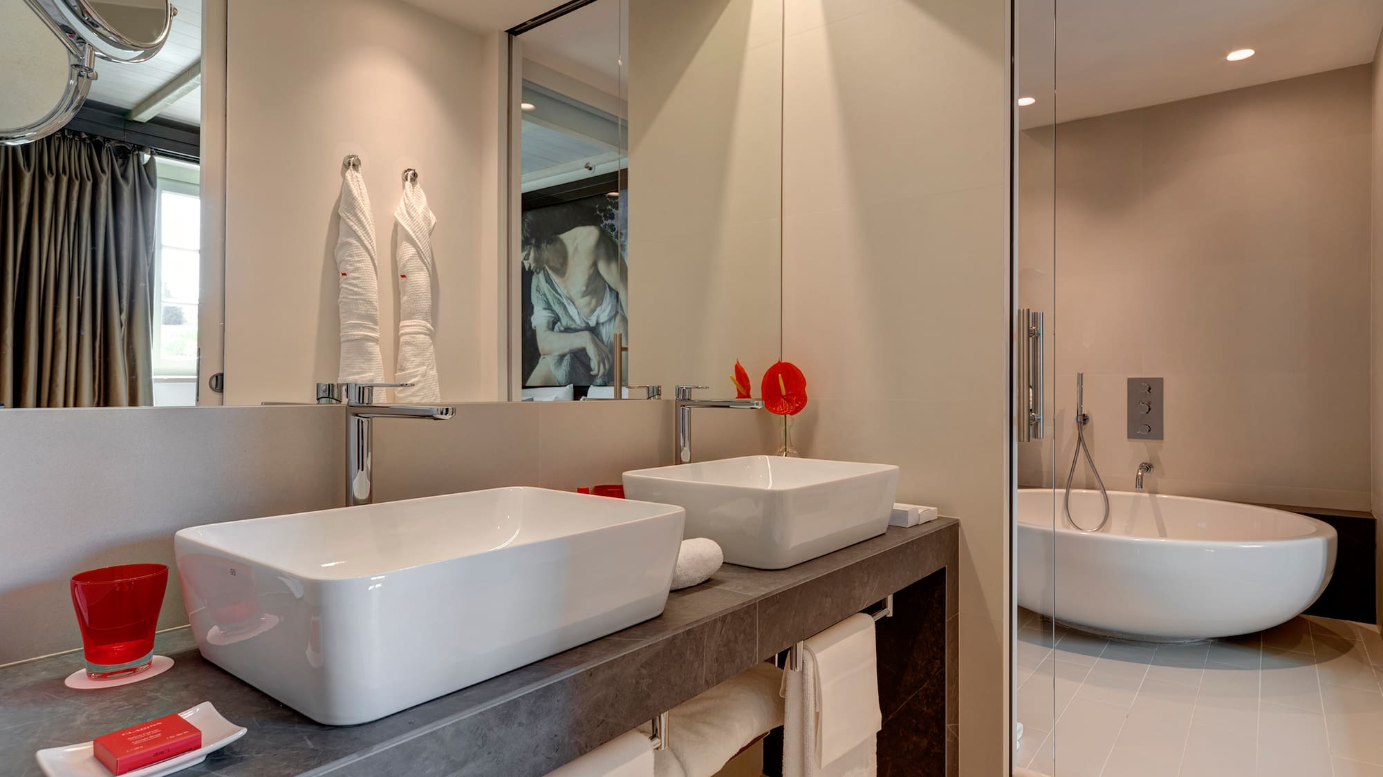 a bathroom with two sinks and a shower