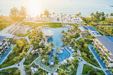 a aerial view of a resort with a pool and palm trees