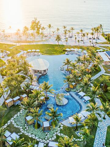 a aerial view of a resort with a pool and palm trees