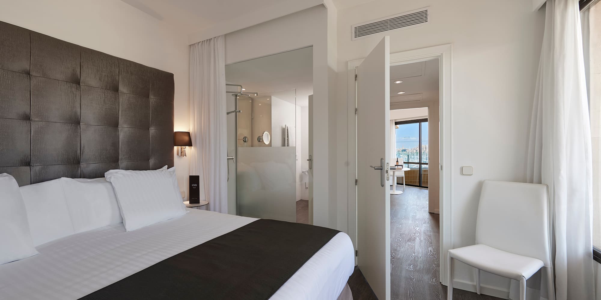 a bedroom with a bed and a chair