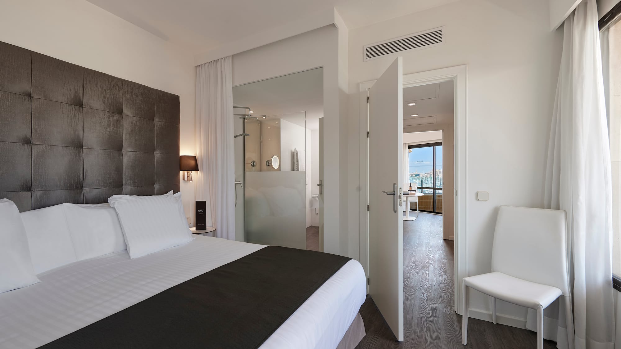 a bedroom with a bed and a chair