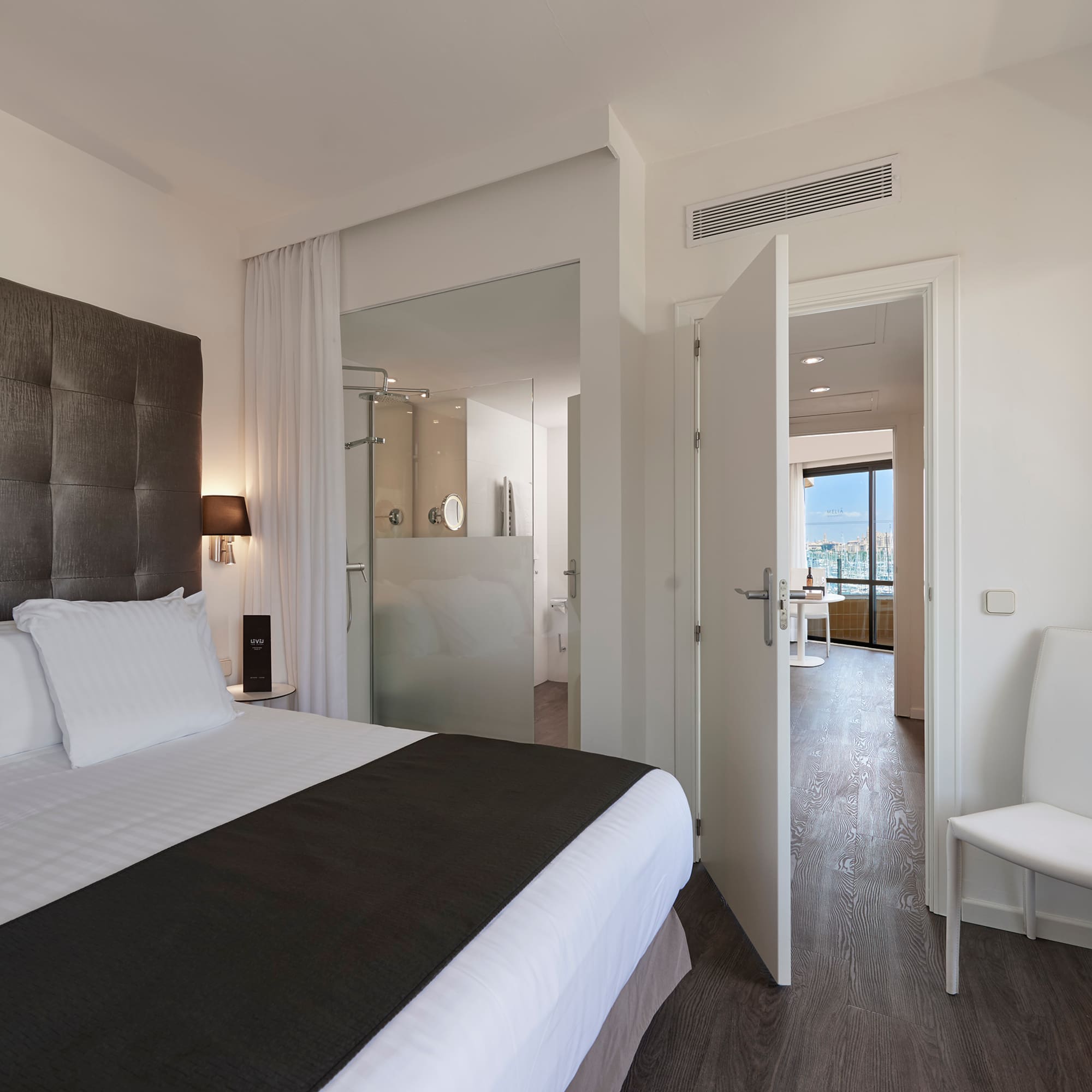 a bedroom with a bed and a chair