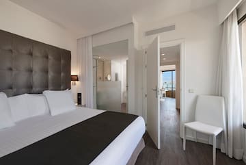 a bedroom with a bed and a chair