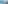 Panoramic balcony view of a sunny bay with boats and a coastal city.