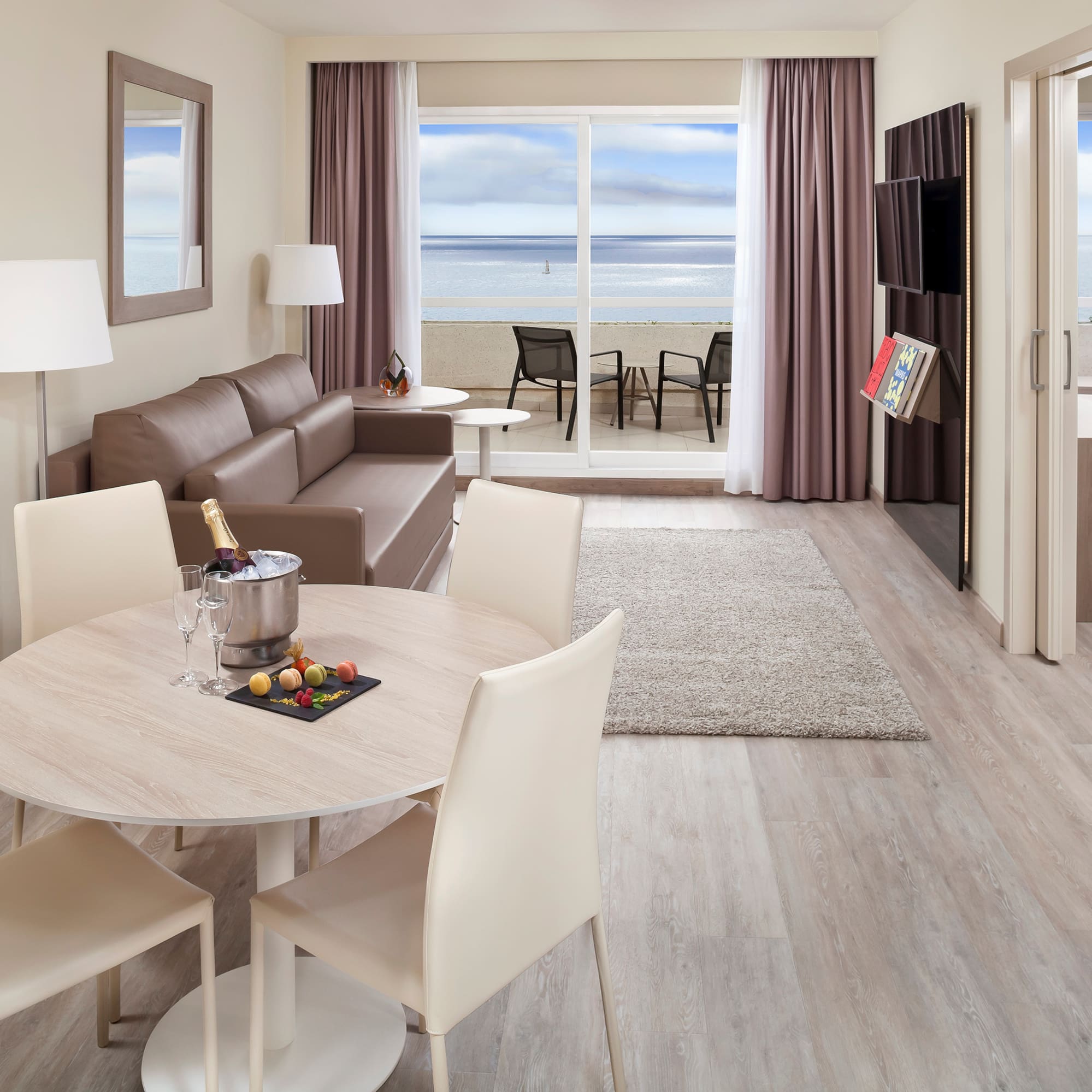 a room with a table and chairs and a couch