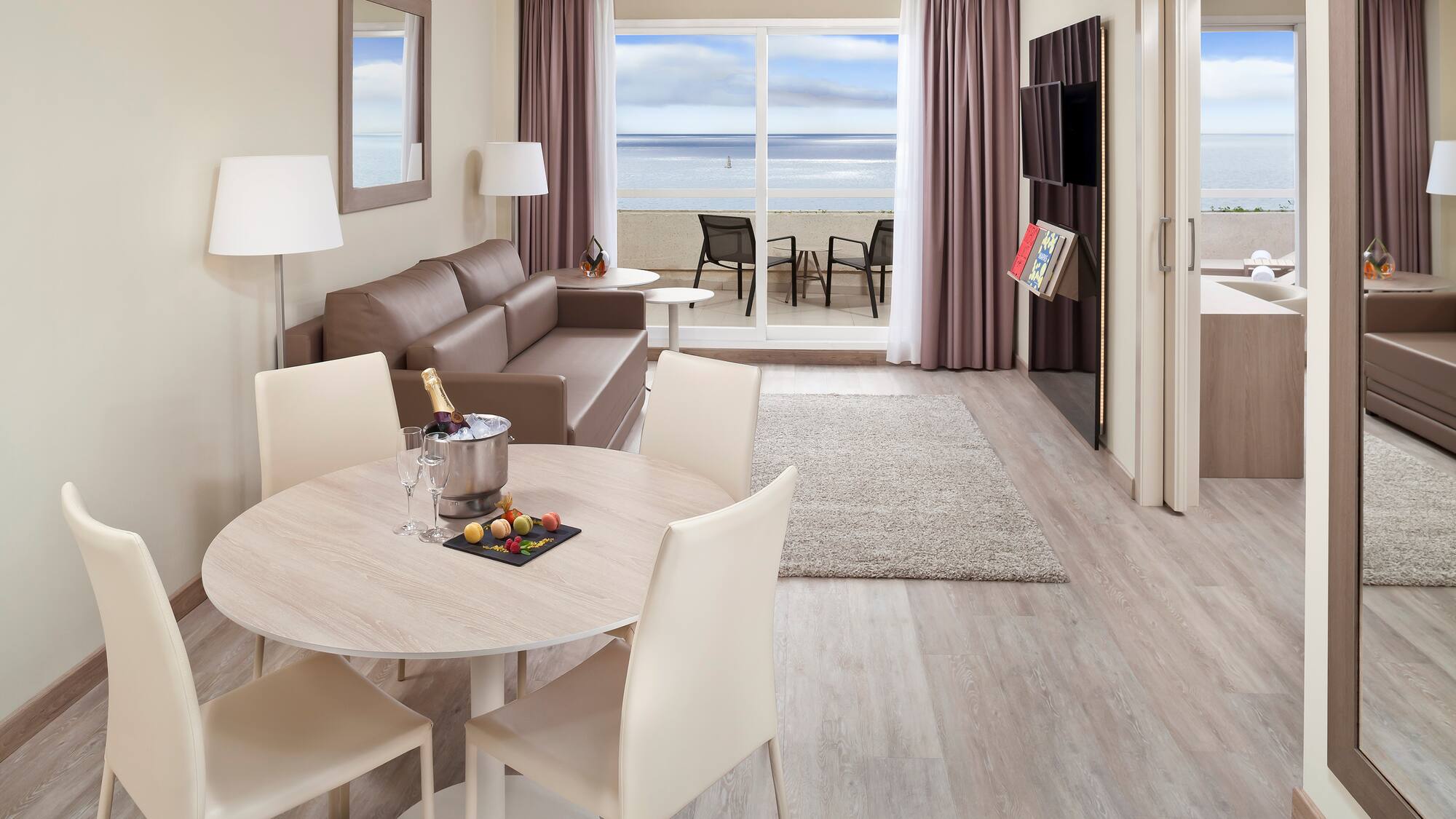 a room with a table and chairs and a couch