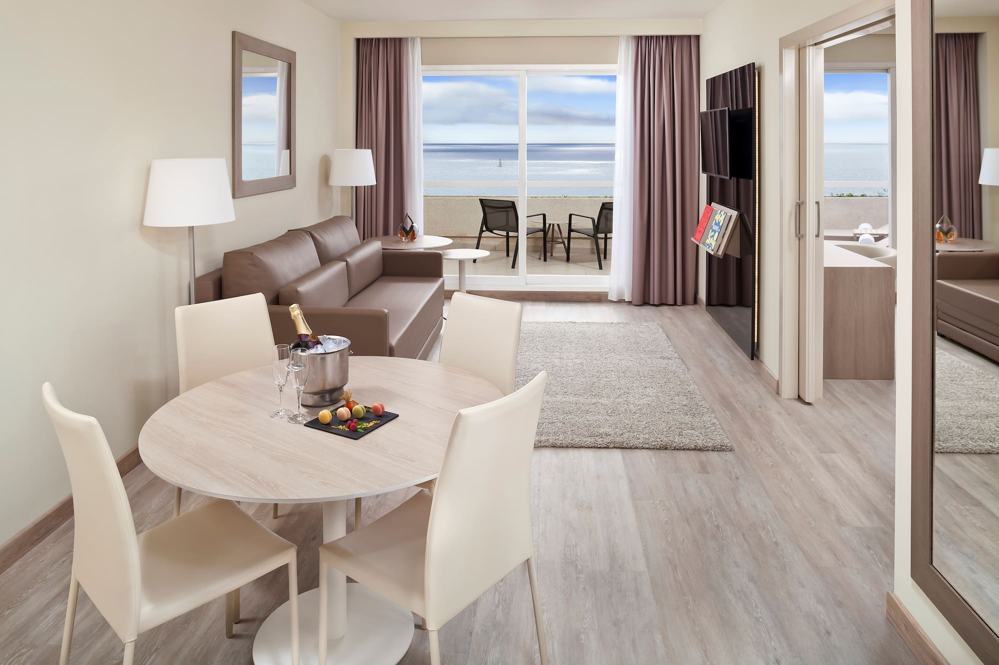 a room with a table and chairs and a couch