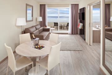 a room with a table and chairs and a couch