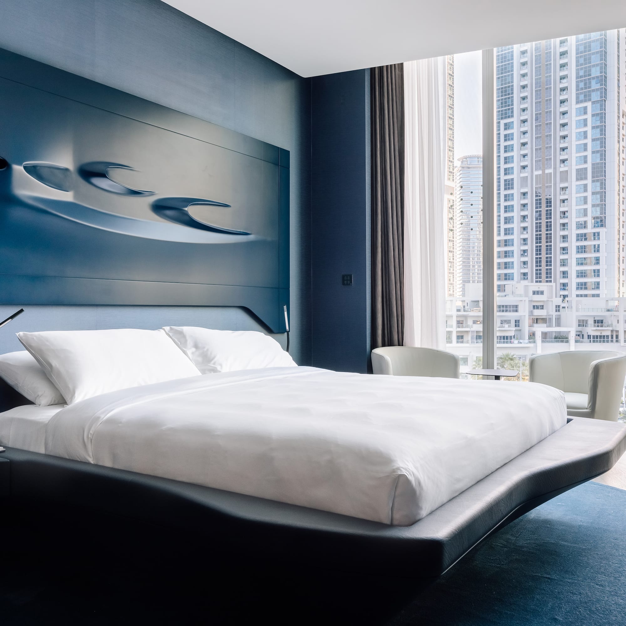 a bedroom with a large bed and a window