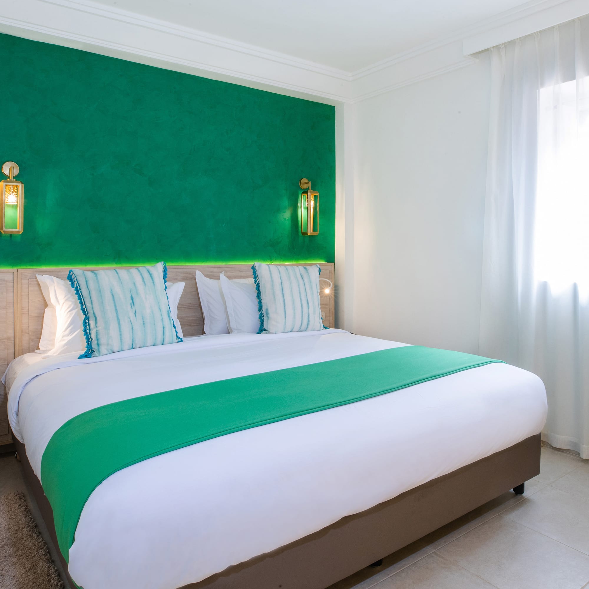 a bed with green and white bedding