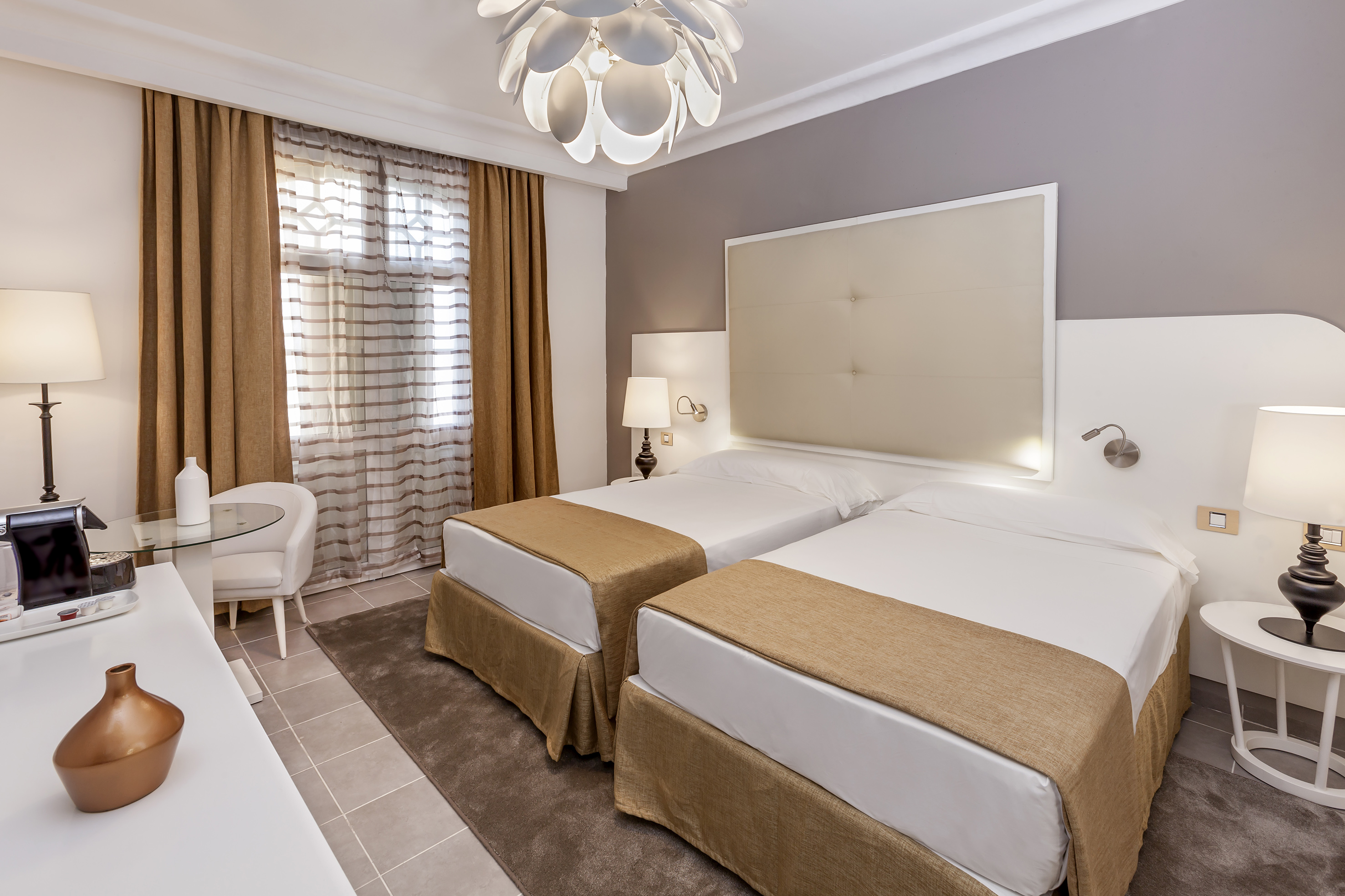 a room with two beds and a lamp