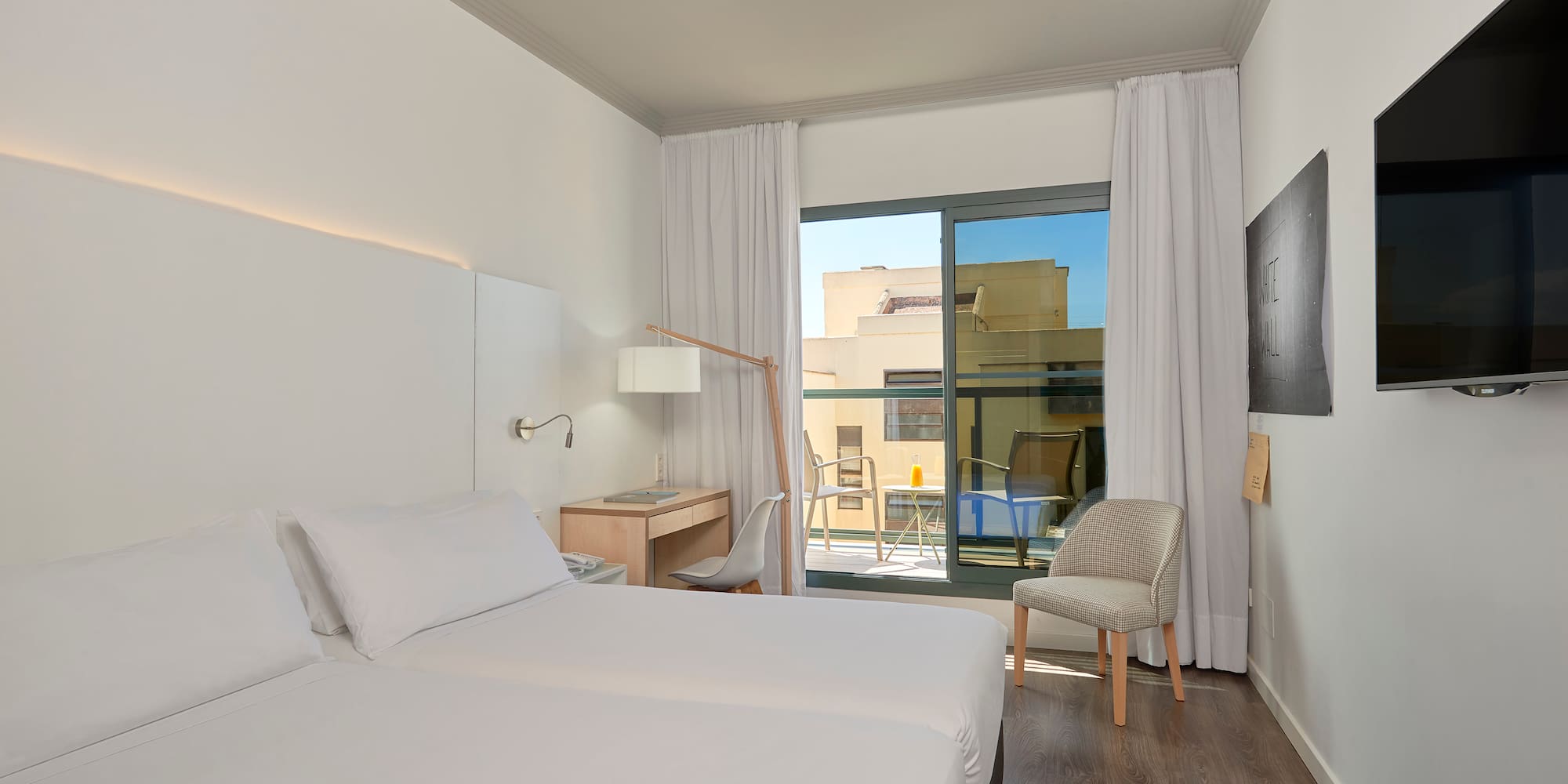 a room with two beds and a chair