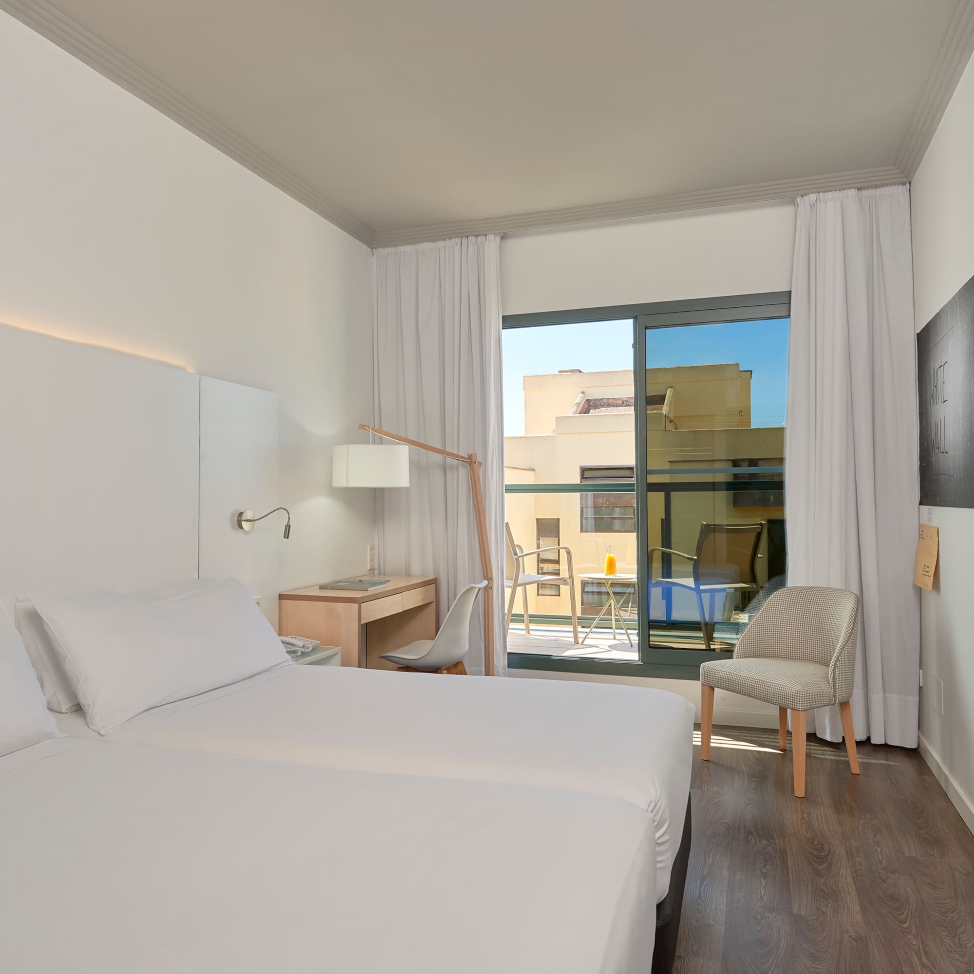 a room with two beds and a chair