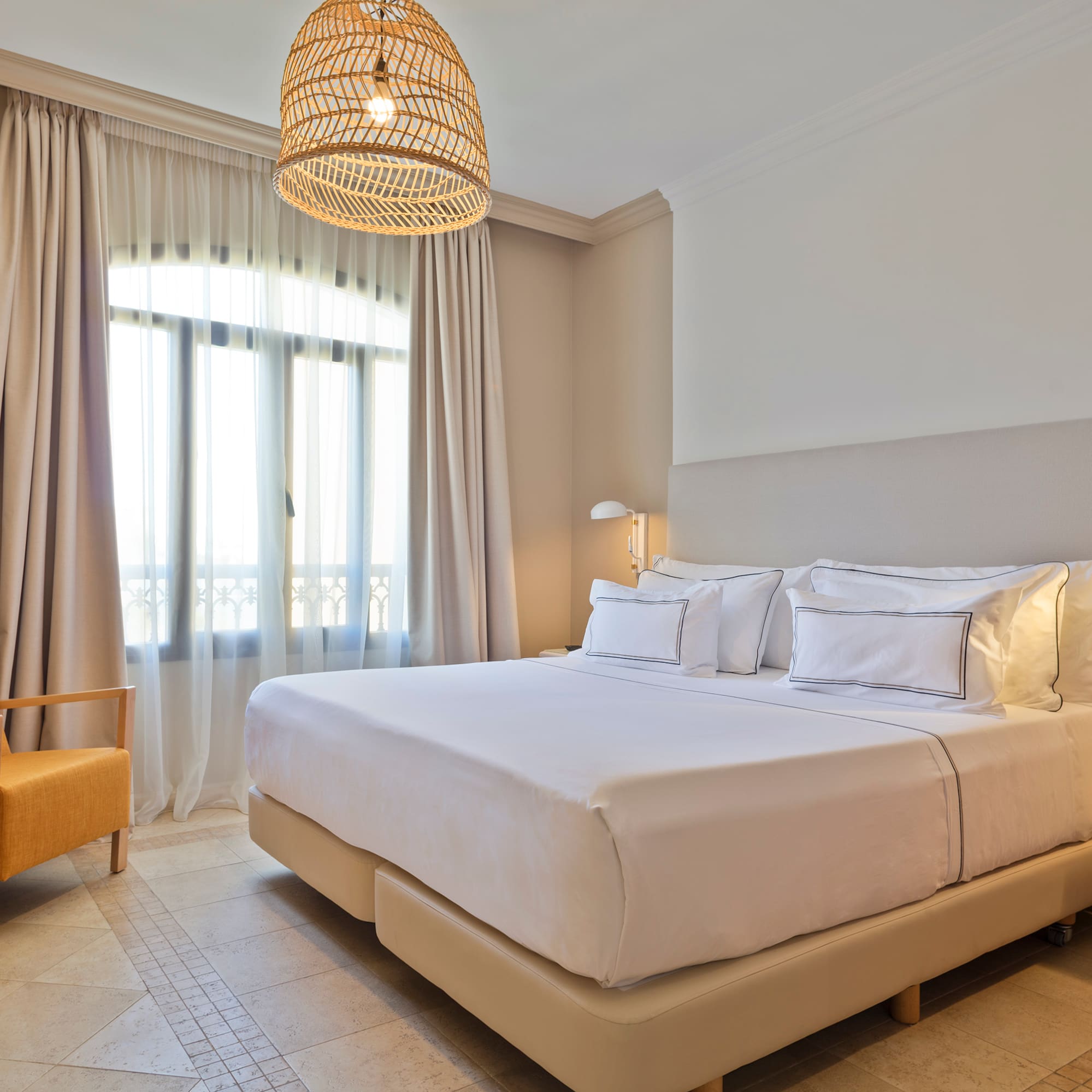 a bedroom with a bed and a chair