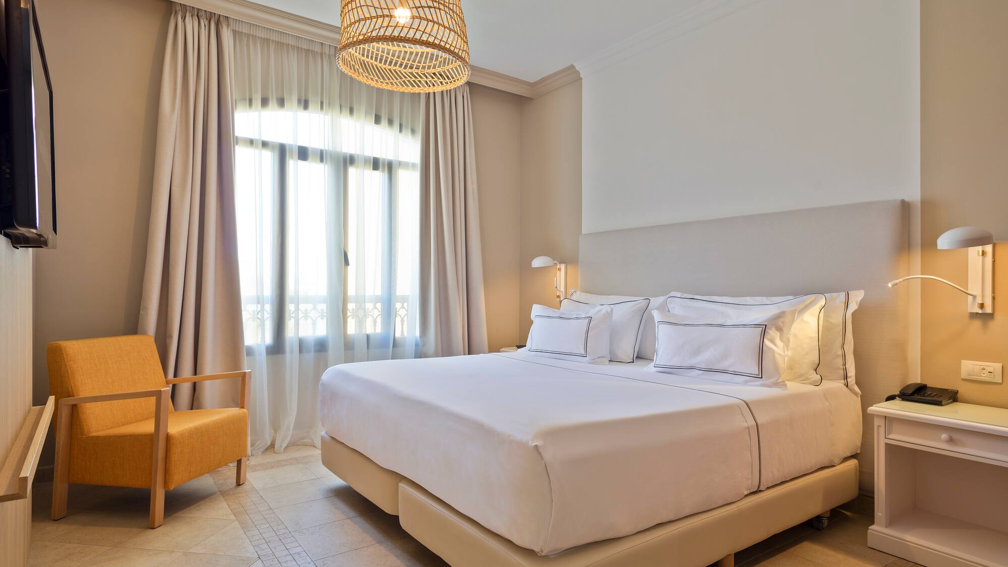 a bedroom with a bed and a chair