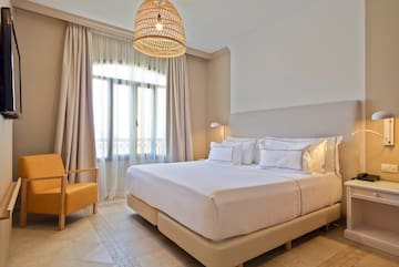 a bedroom with a bed and a chair