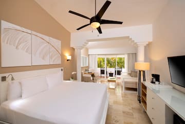 a room with a bed and a ceiling fan