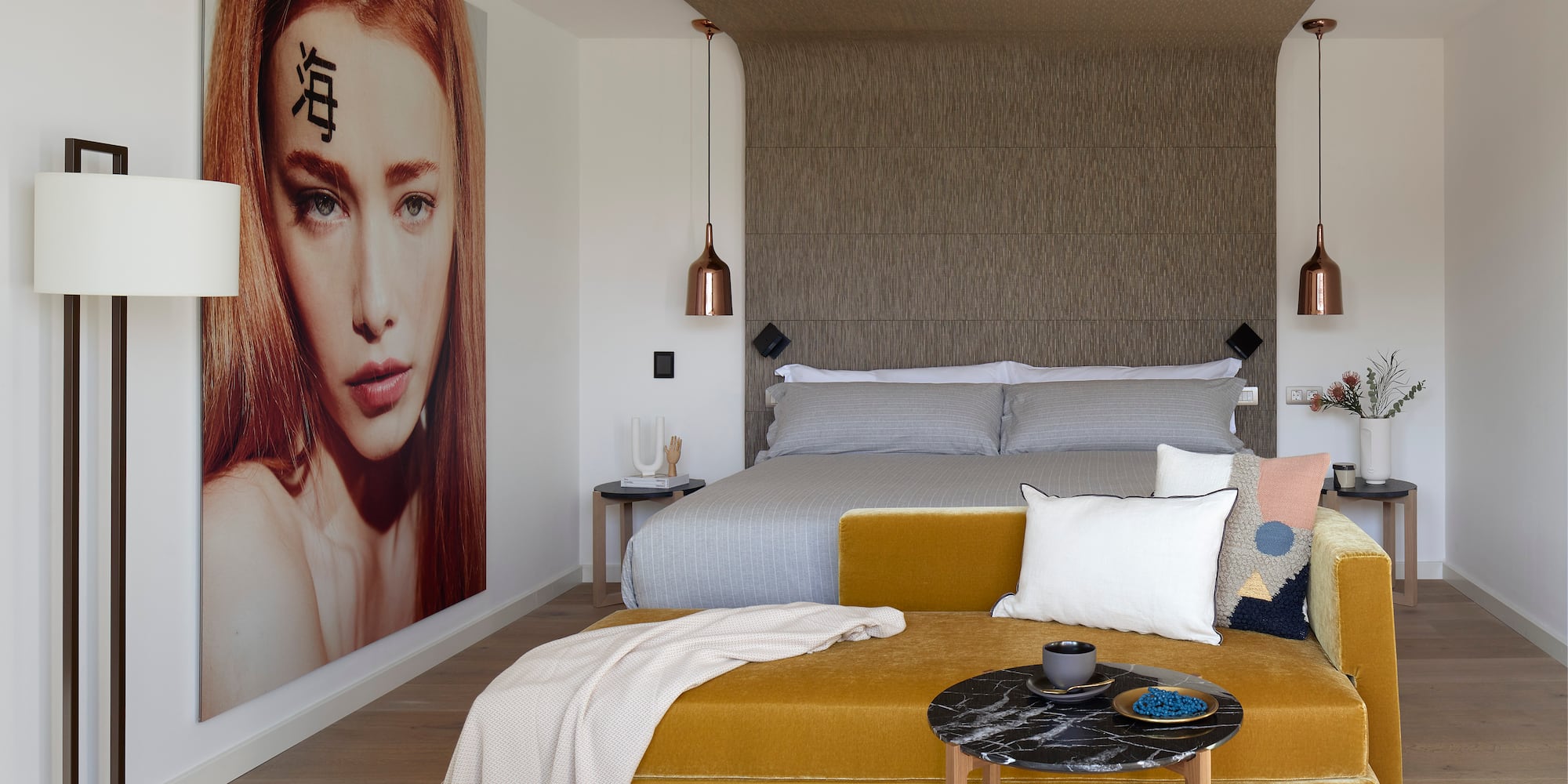 a bedroom with a bed and a poster on the wall