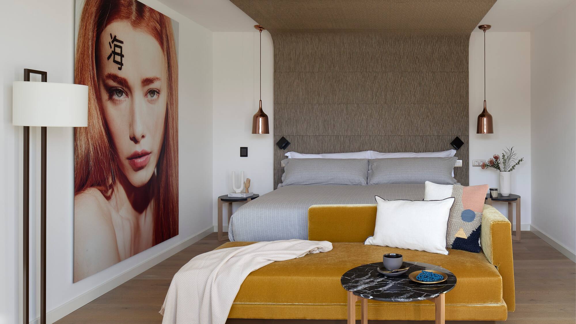 a bedroom with a bed and a poster on the wall