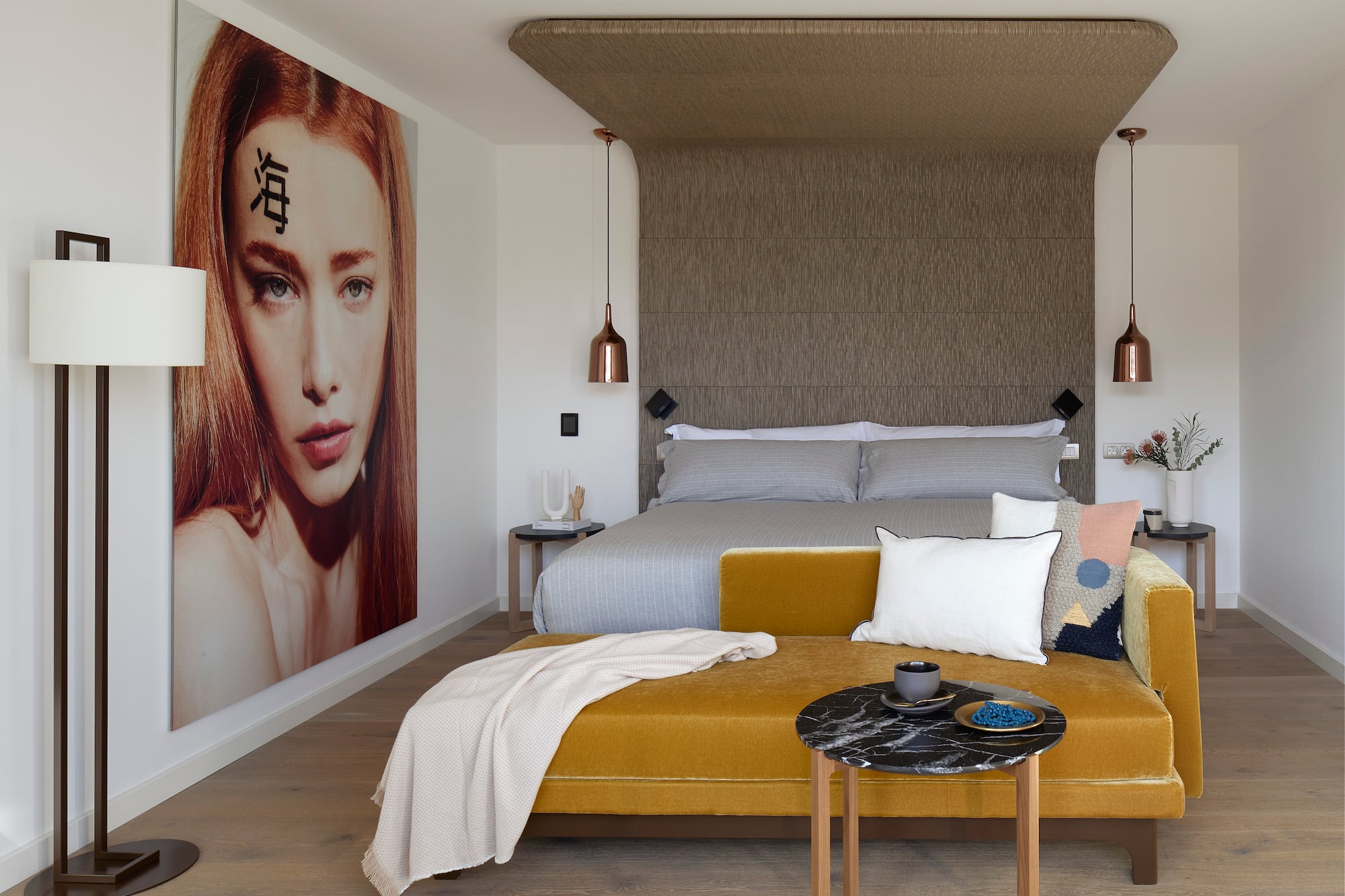 a bedroom with a bed and a poster on the wall