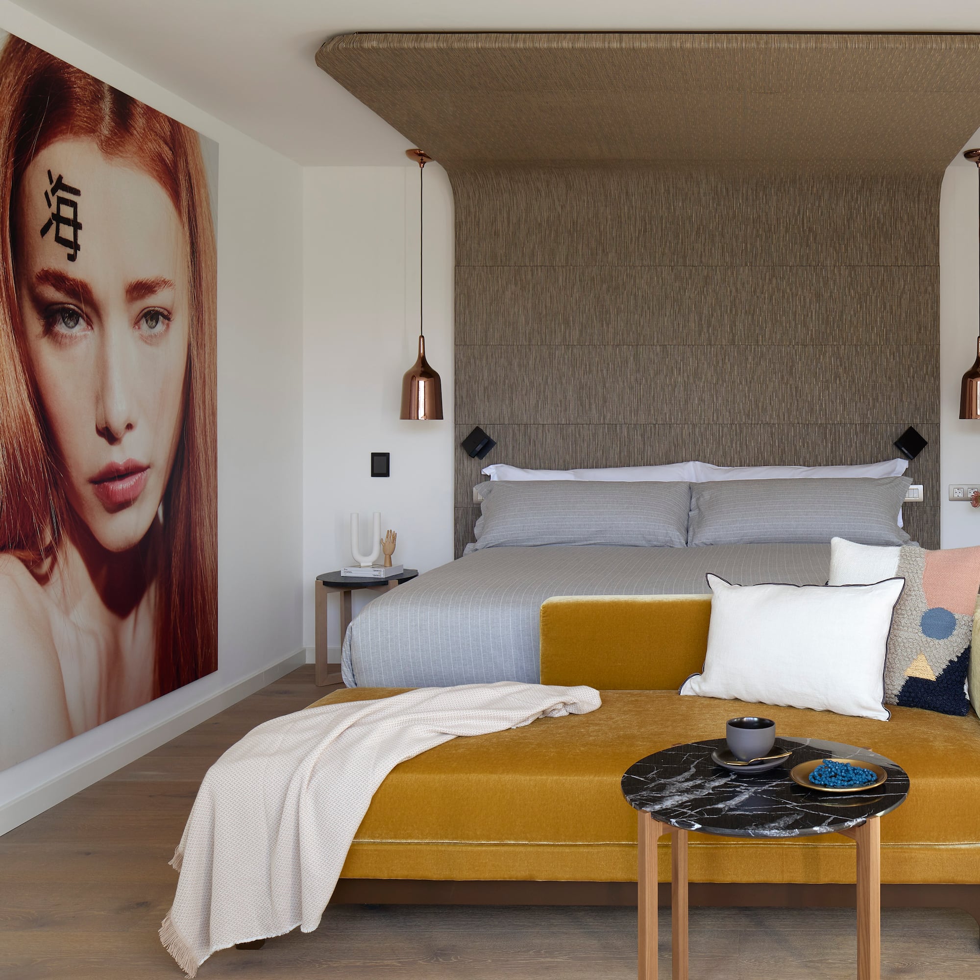 a bedroom with a bed and a poster on the wall