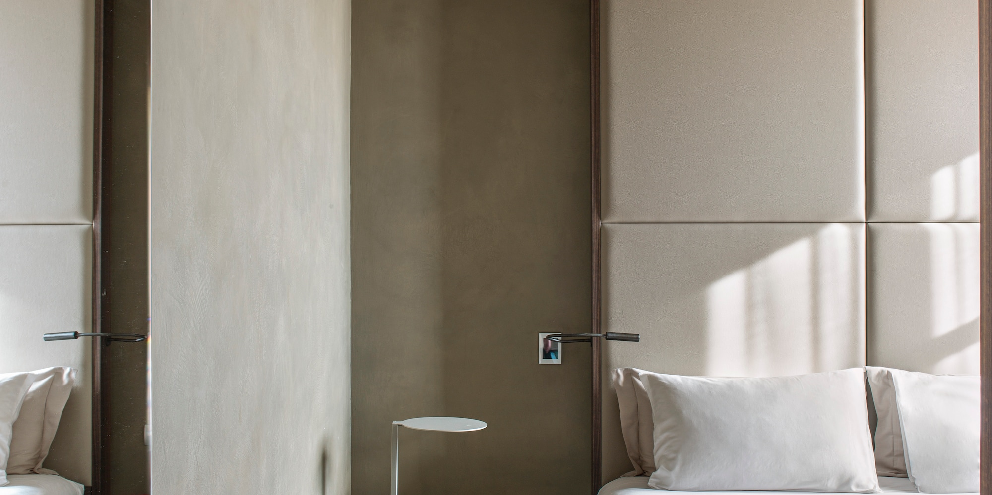 a bedroom with a bed and a table