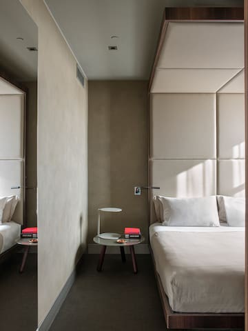 a bedroom with a bed and a table