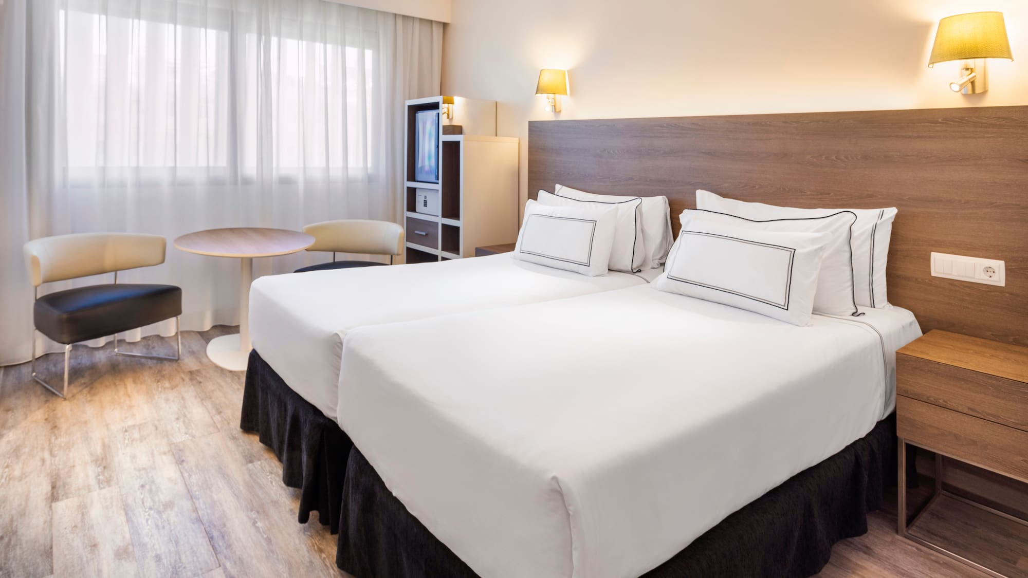 a hotel room with two beds