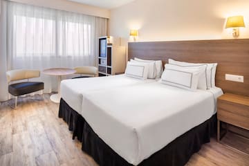 a hotel room with two beds