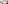Modern hotel room with two twin beds, wooden headboard, and seating area.