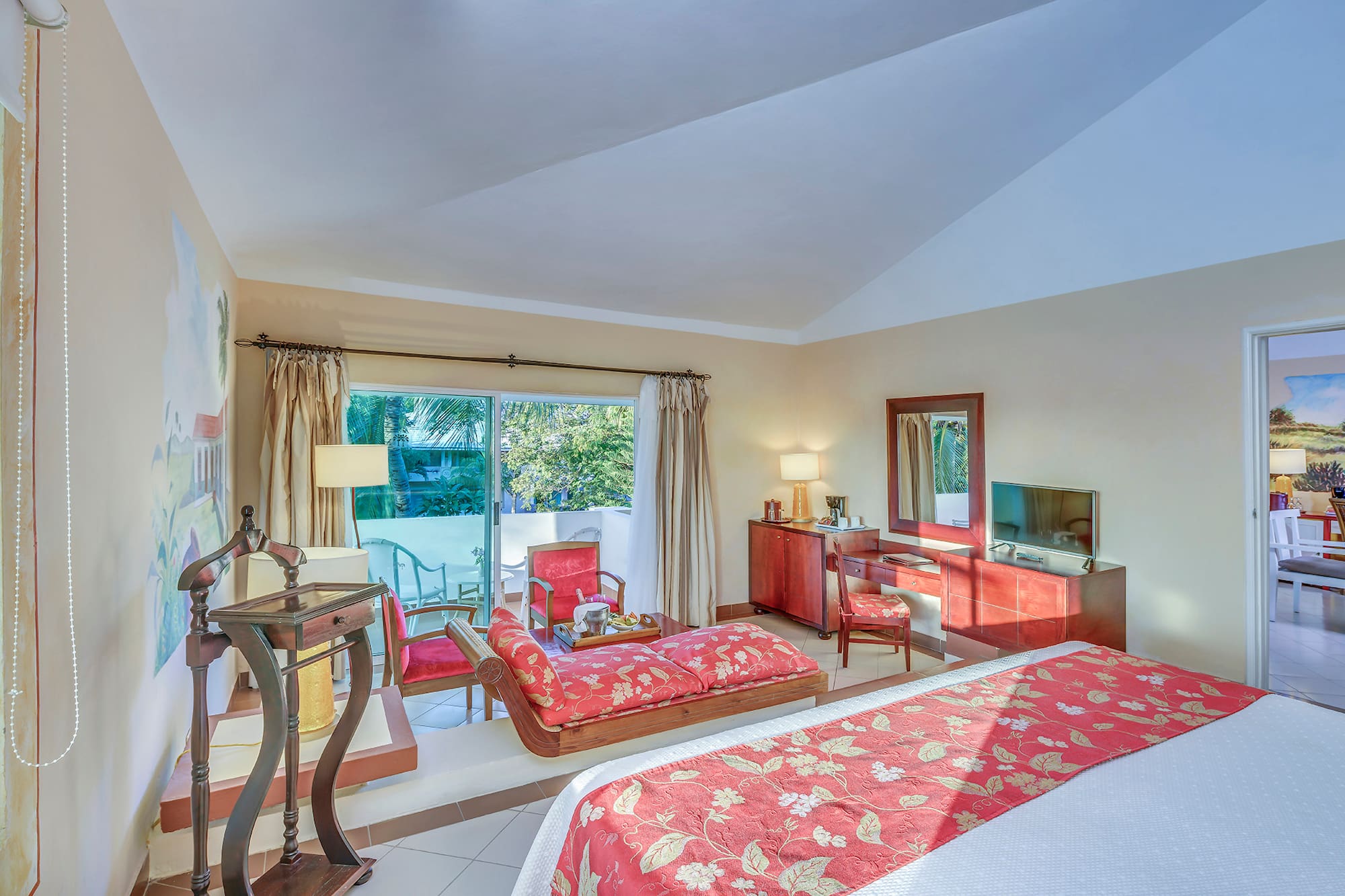 a bedroom with a bed and a television