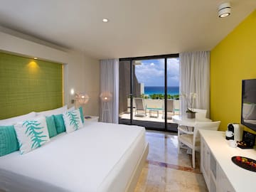 a room with a bed and a table and chairs