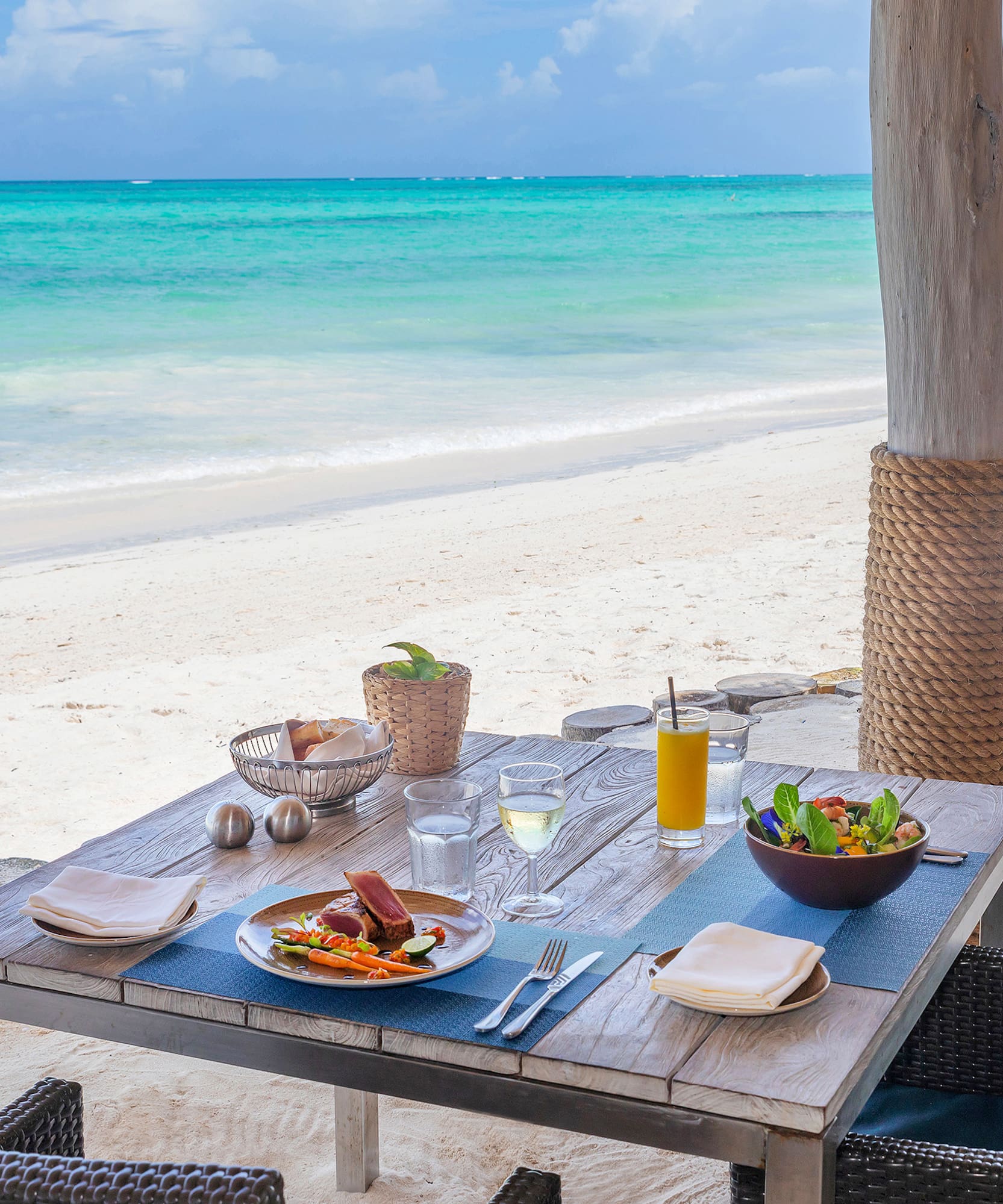 a table with food on it on a beach