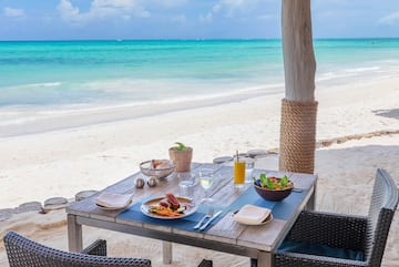 a table with food on it on a beach