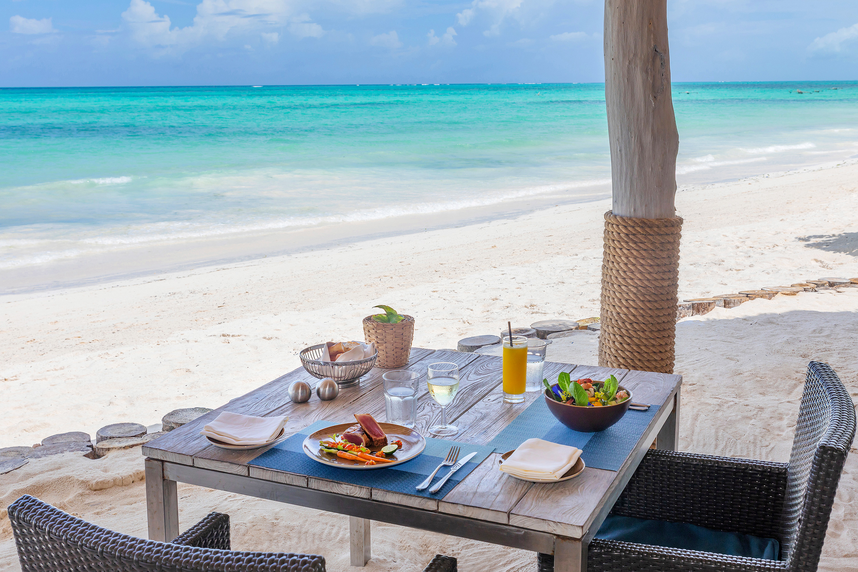 a table with food on it on a beach
