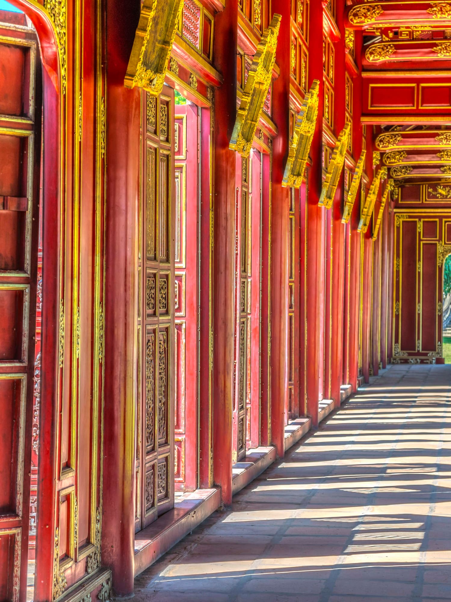a long corridor with red walls and gold trim