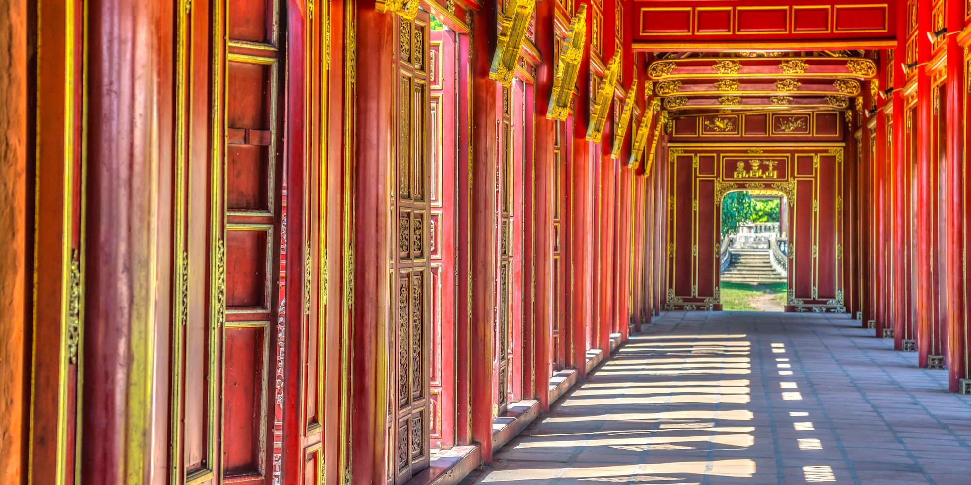 a long corridor with red walls and gold trim