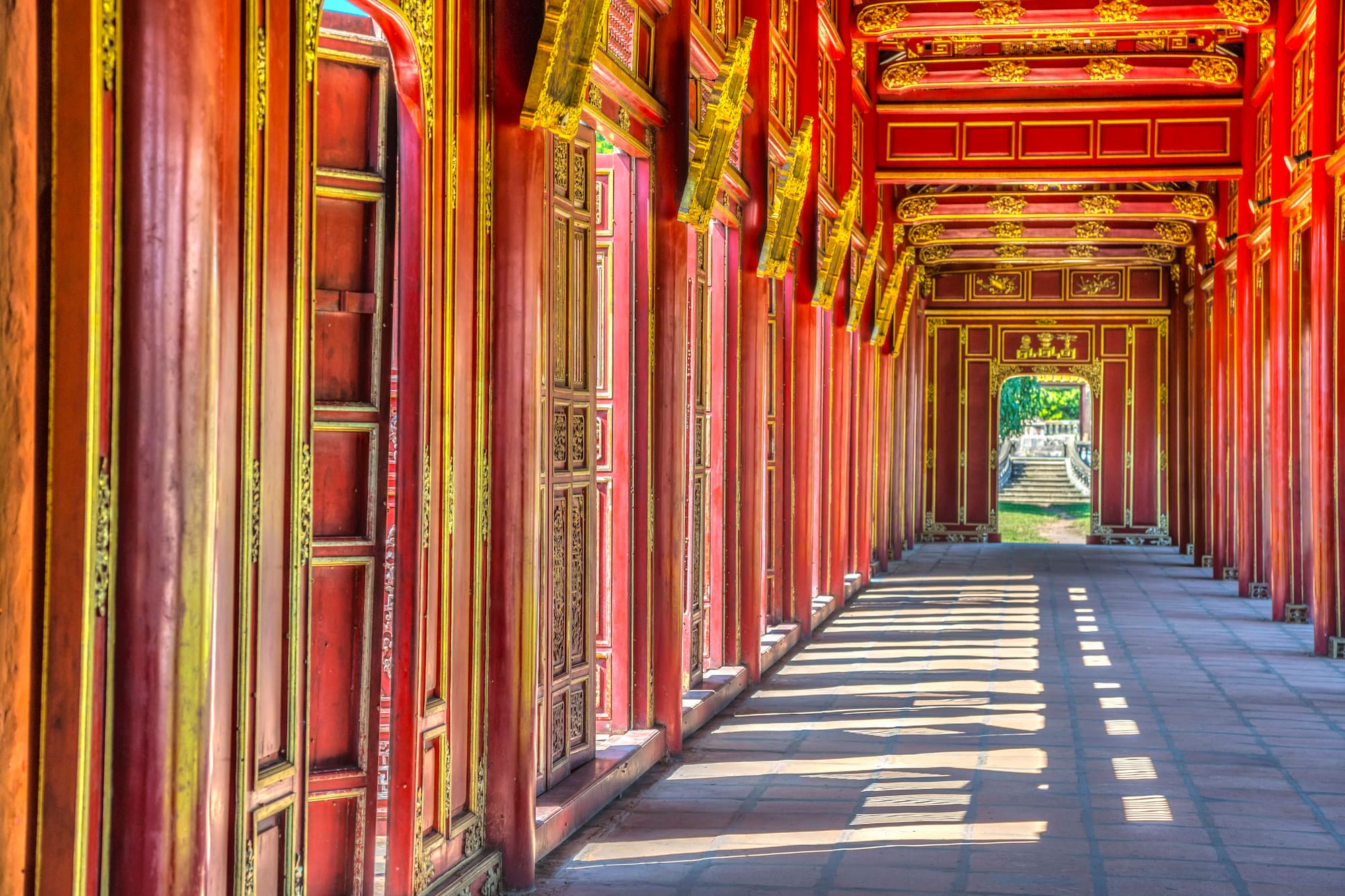 a long corridor with red walls and gold trim