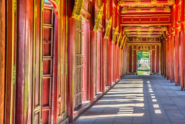 a long corridor with red walls and gold trim