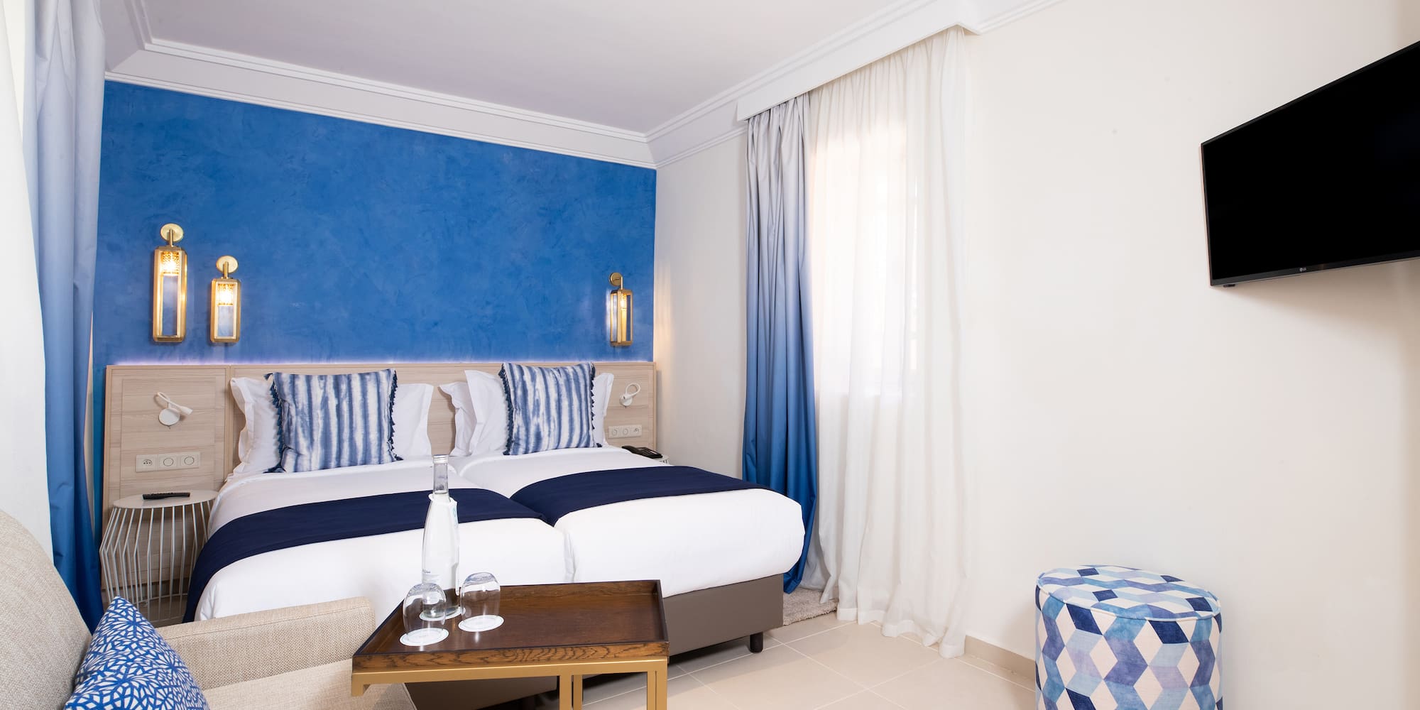 a room with a bed and a stool