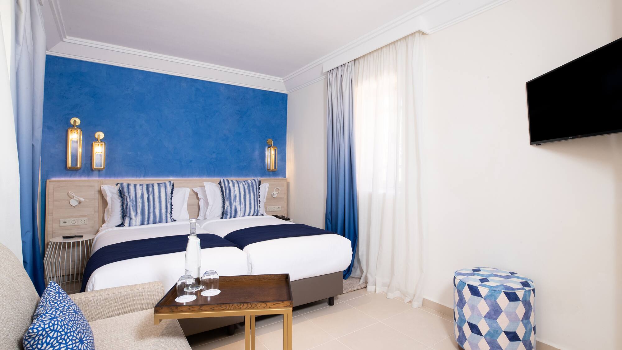 a room with a bed and a stool