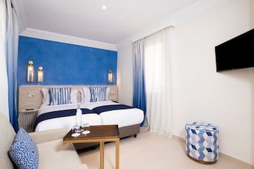 a room with a bed and a stool