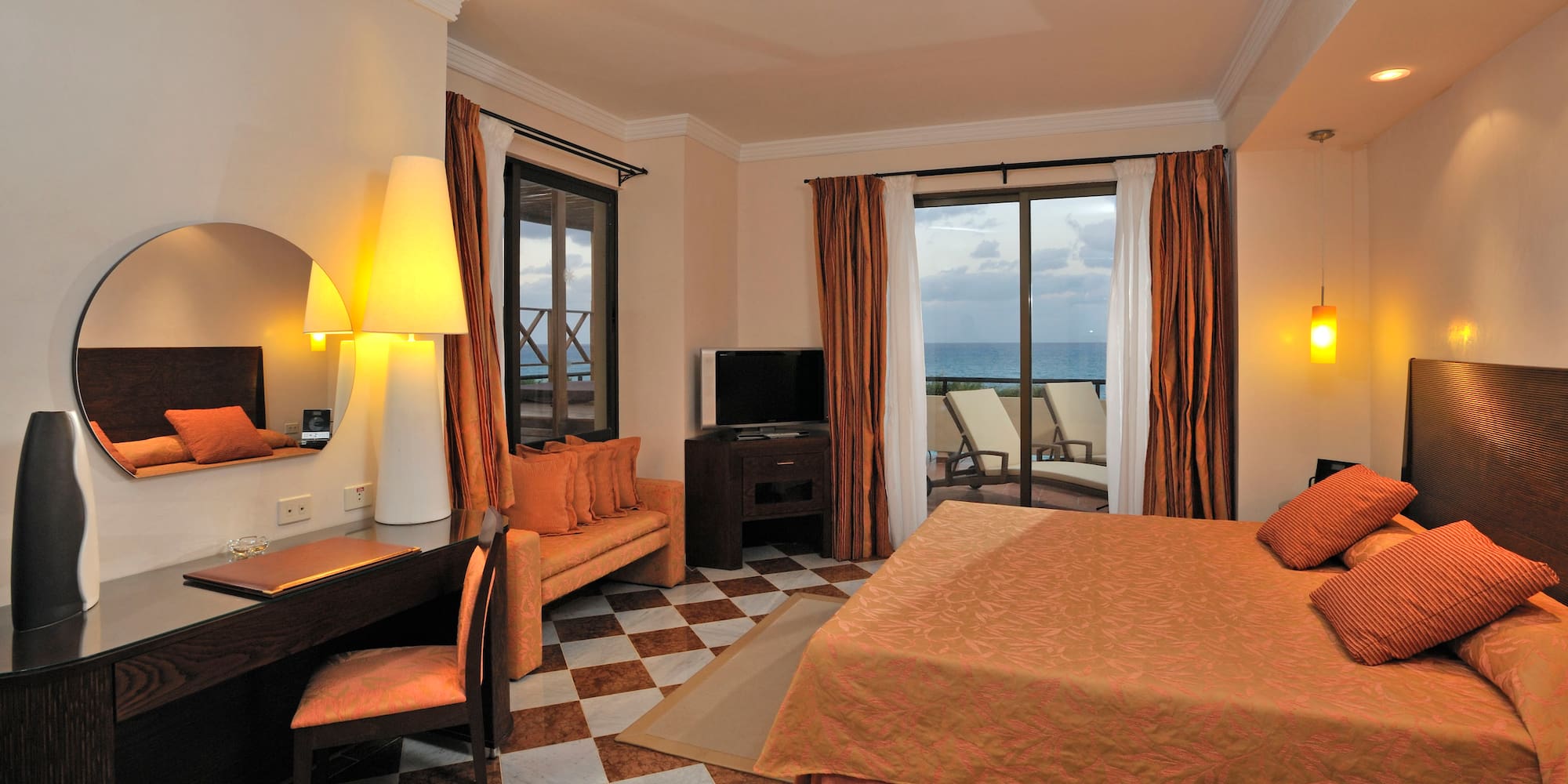 a room with a bed and a table and chairs