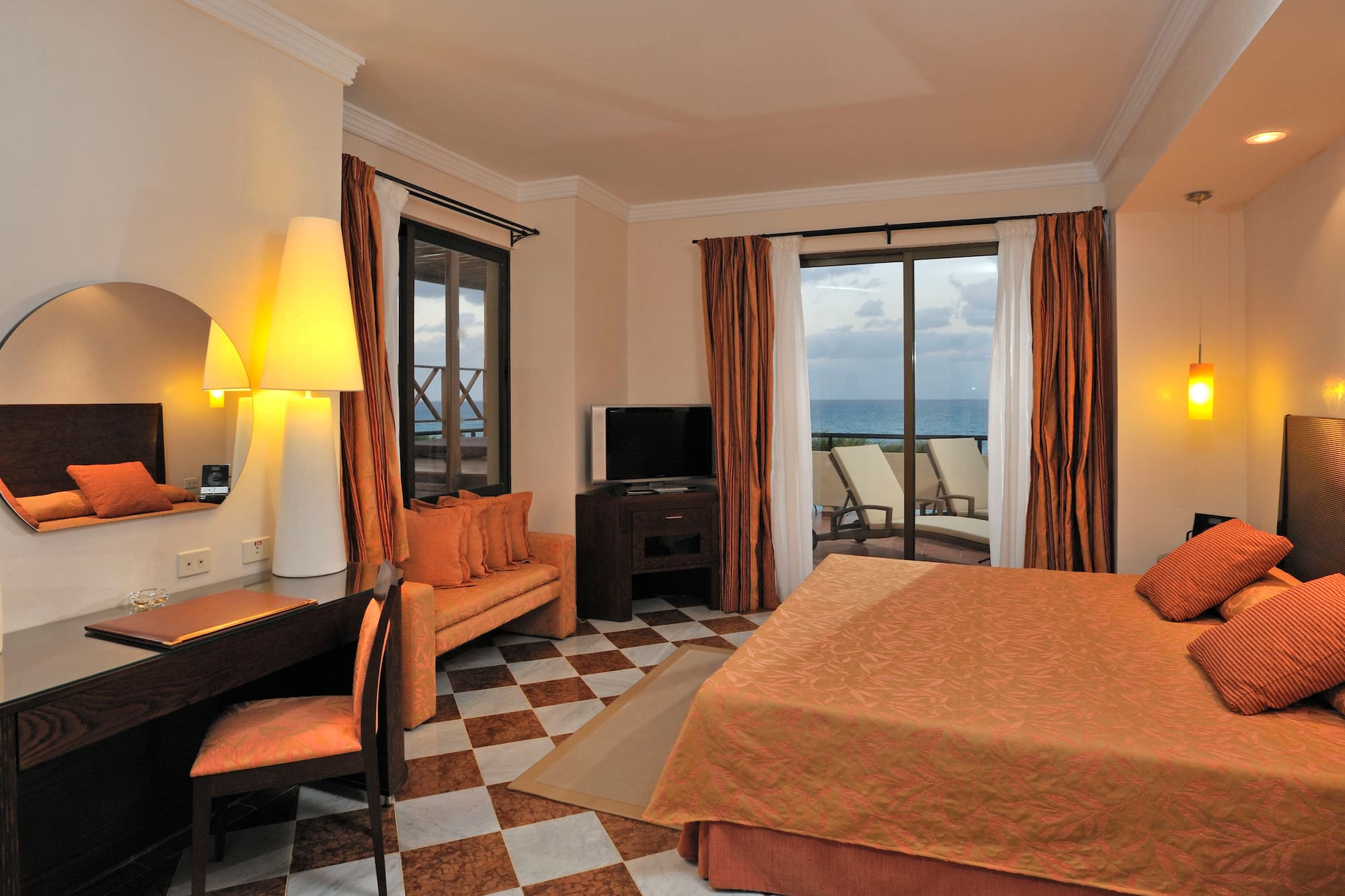 a room with a bed and a table and chairs