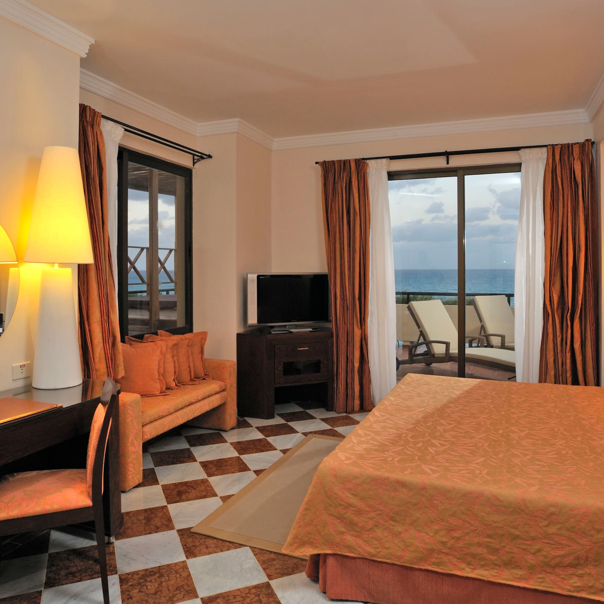 a room with a bed and a table and chairs