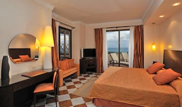 a room with a bed and a table and chairs