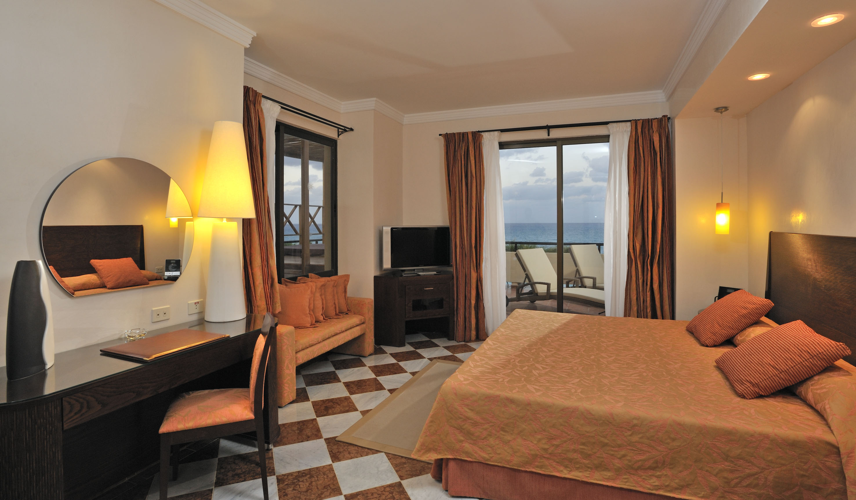 a room with a bed and a table and chairs