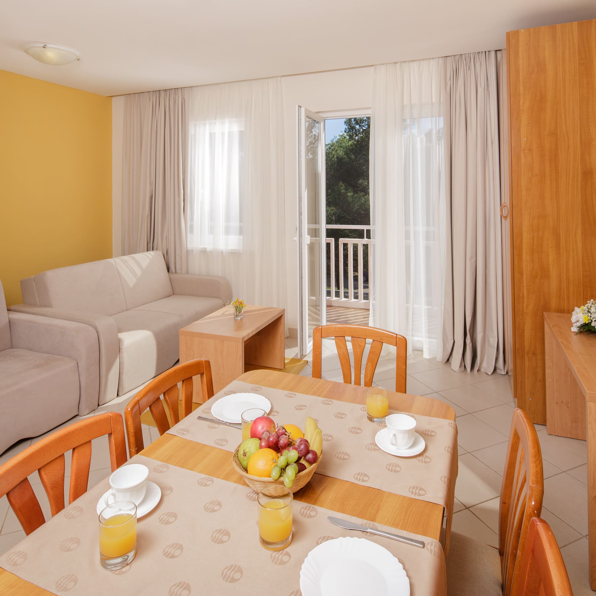 a room with a table and chairs and a couch