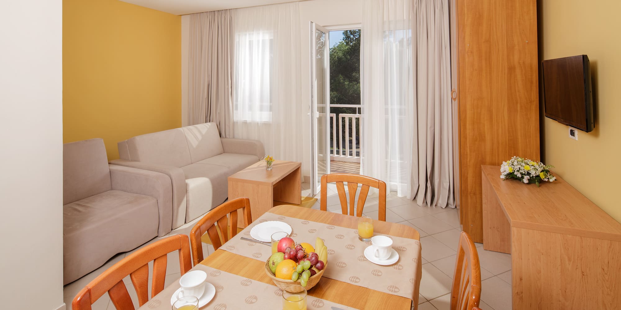 a room with a table and chairs and a couch